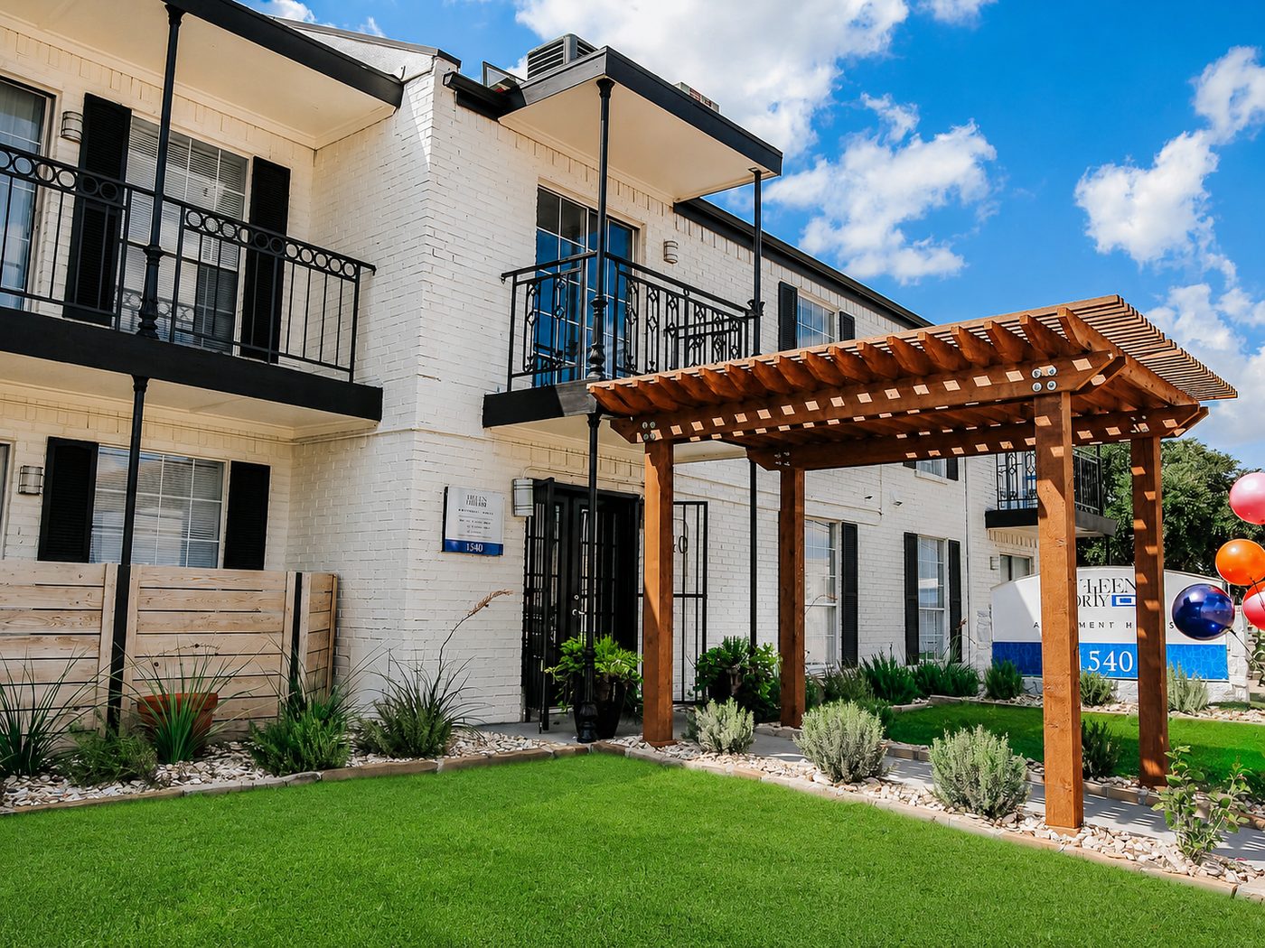 Building exterior with pergola and landscaping at 1540 Apartments