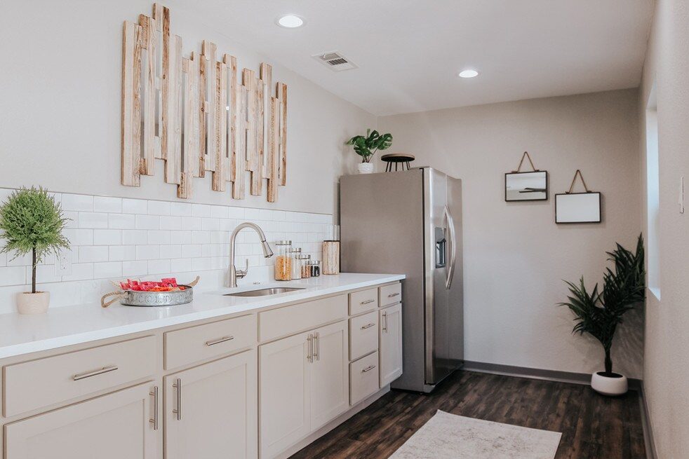 Renovated kitchen with white cabinetry and stainless steel appliances