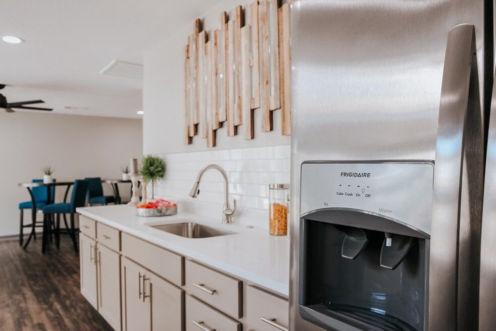 Kitchen island with stainless appliances and bar seating